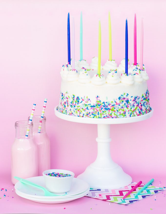 vanilla butter cake with sprinkles and tall candles