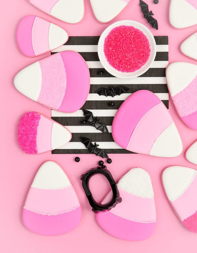 close up of pink candy corn cookies on pink backdrop