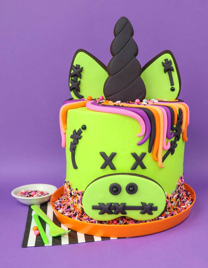 zombie unicorn cake with purple backdrop