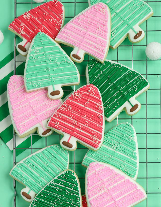 several layers of bottle brush Christmas cookies on a mint green backdrop