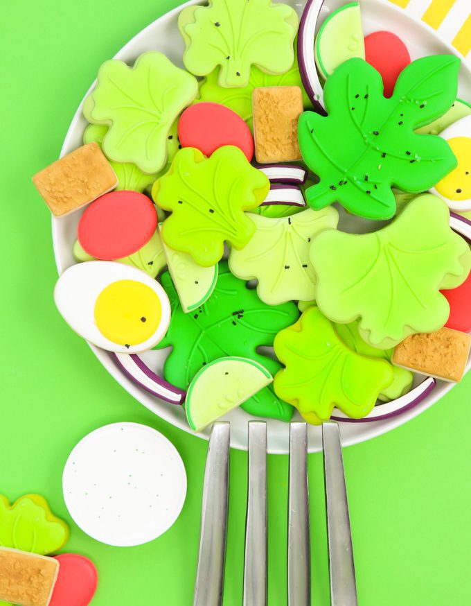 a platter of salad sugar cookies with a giant silver fork