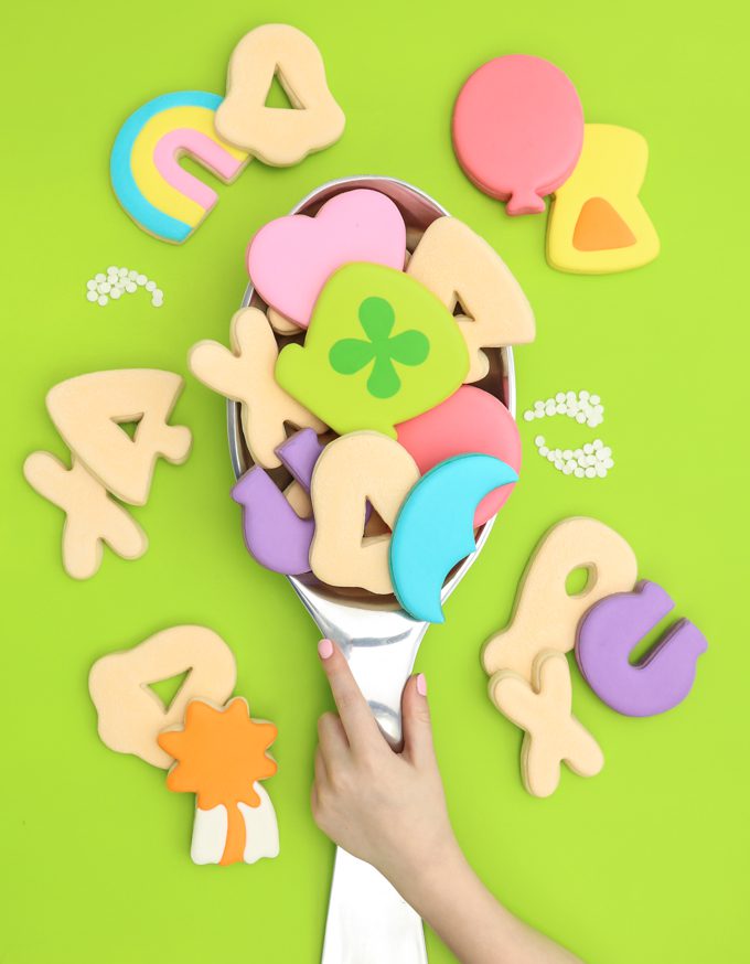 large lucky charms cookies on giant spoon with hand