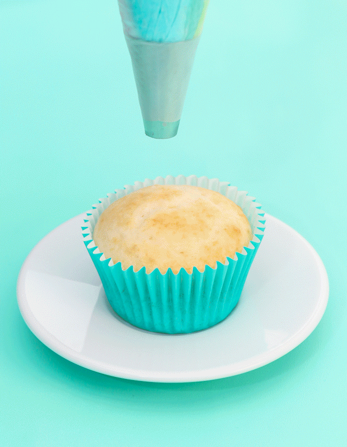 GIF of how to frost a rainbow swirl cupcake.