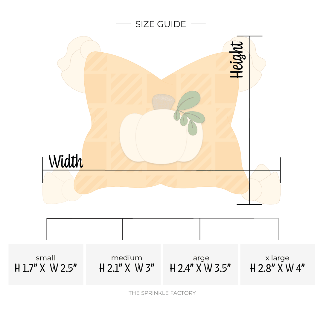 Clipart of an orange pillow with a plaid pattern and a cream pumpkin in the middle with cream tassels on the corners with size guide.
