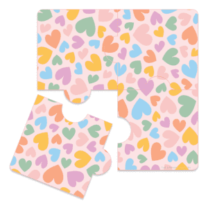Clipart of a rainbow heart print covered 4 piece puzzle in a square shape with one of the pieces offset and tilted to show its size.