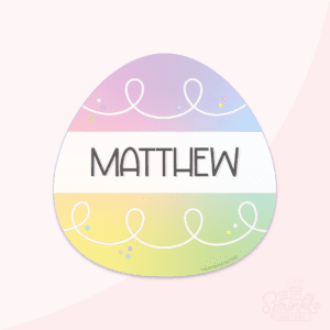 Clipart of a rainbow easter egg with a white white stripe and the name MATTHEW on it in black with white swirls on the top and bottom.
