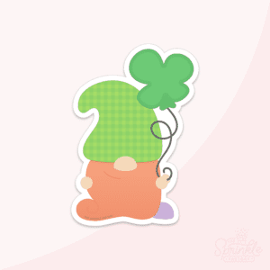 Clipart of a gnome with a long red beard covering his feet and his nose sticking through wearing a green hat with a plaid print holding a string with a shamrock shaped balloon.