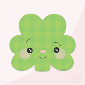 Digital image of a green clover with a smiling face and a green plaid print.