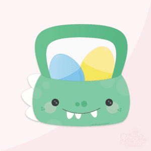 Clipart of a green dinosaur easter basket with white spikes on the left of the basket and black face details with white teeth. There is a blue and a yellow plastic egg in the basket.