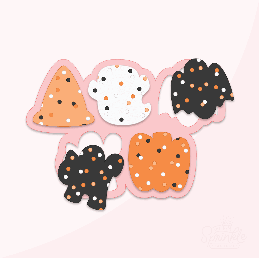 Digital image of frosted animal crackers in the shape of a orange witch hat, white ghost, black bat, black cat and an orange pumpkin with orange, white and black round sprinkles in front of an outline of a pink cookie cutter.