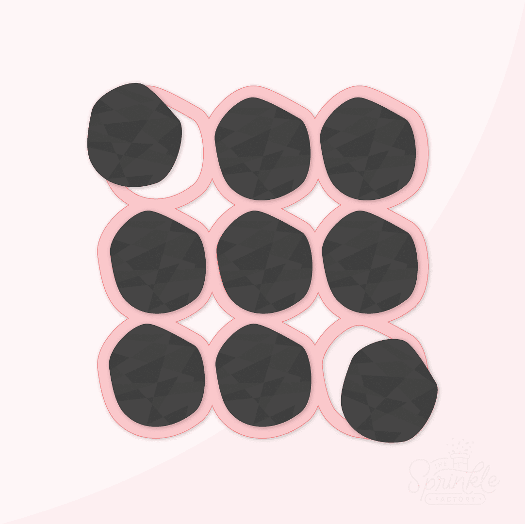 Clipart of pink lump of coal multi cutter with 9 black lumps of coal.
