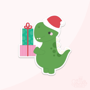 Green T-rex dinosaur wearing a red santa hat holding stacked green and pink presents with red ribbon.